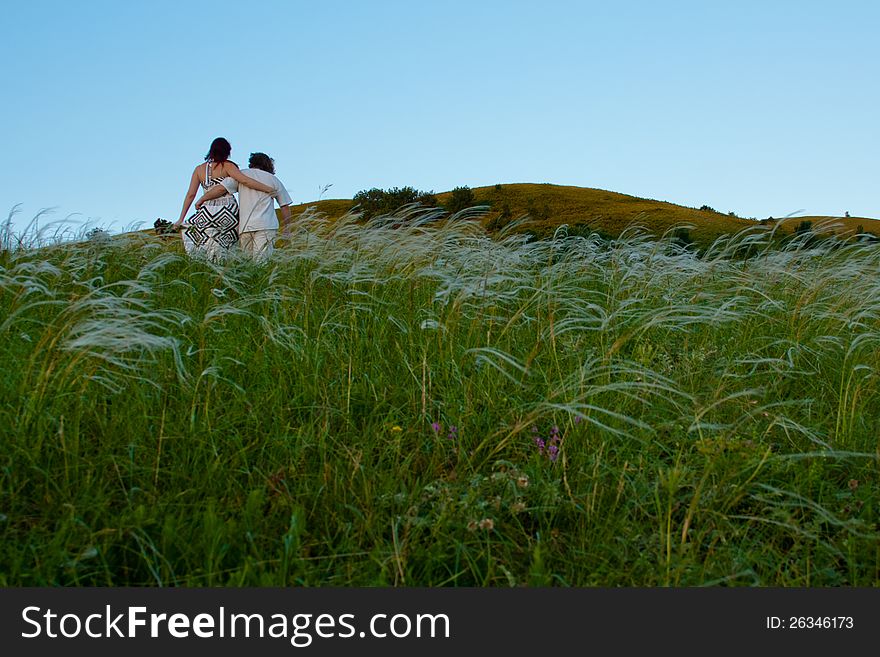 Young men and women on the mountain with flowers. Young men and women on the mountain with flowers.