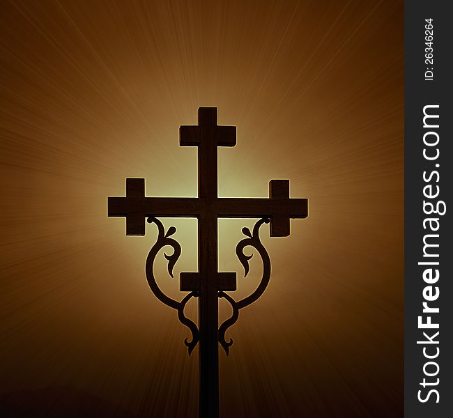 Highlighted shining cross cross on a dark background. Highlighted shining cross cross on a dark background