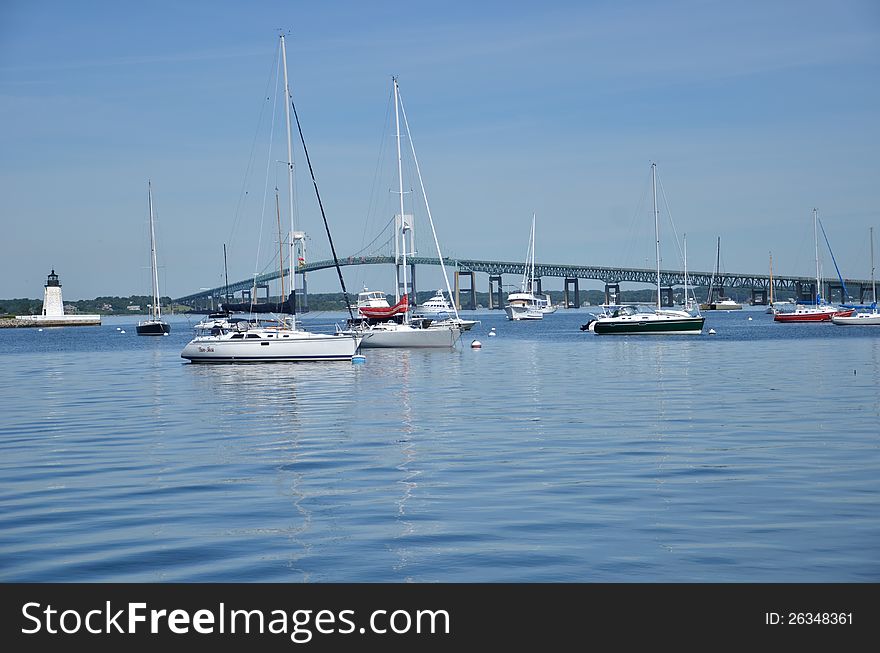 A background with blue water and blue sky and several boats in the island Newport