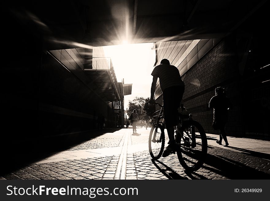 Silhouette of a man biking in the city. Silhouette of a man biking in the city