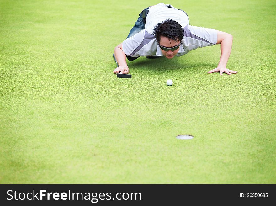 Golfer Checking Line Of Putt