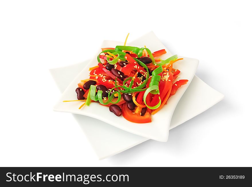 A salad of tomatoes, sweet peppers, red beans, carrots with sesame