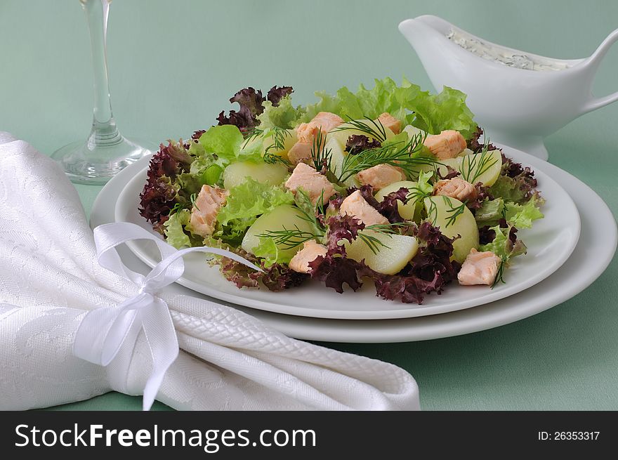 Warm potato salad with salmon salad and sour sauce