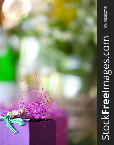 Purple gift box close-up with blurred abstract background