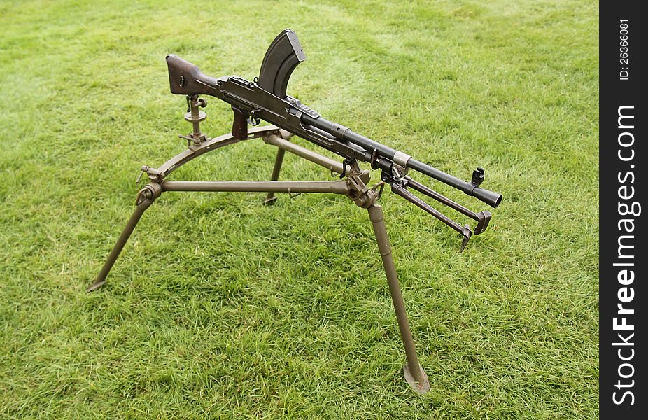 A Vintage Military Machine Gun on a Tripod Stand. A Vintage Military Machine Gun on a Tripod Stand.