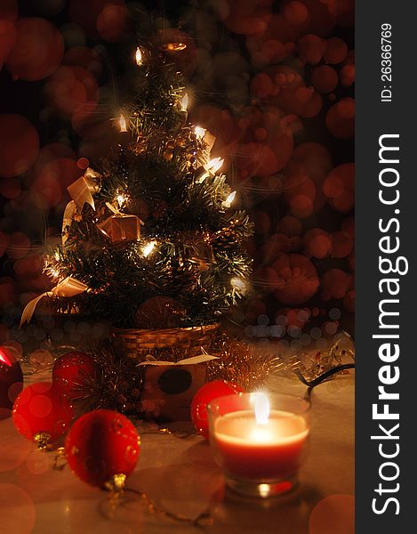 Christmas tree with lights and candles over black, tree in focus
