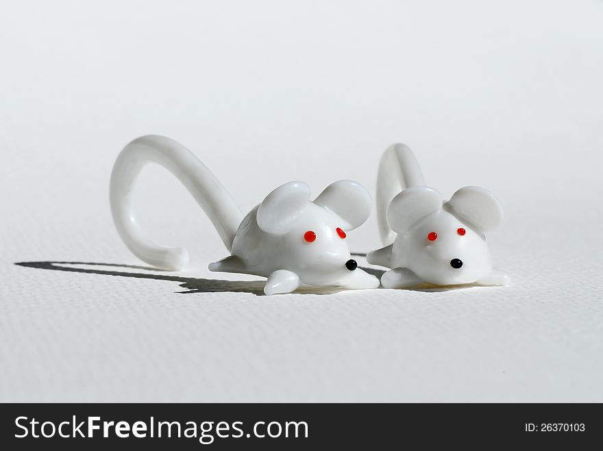 Two mice from white glass with red eyes. Two mice from white glass with red eyes.