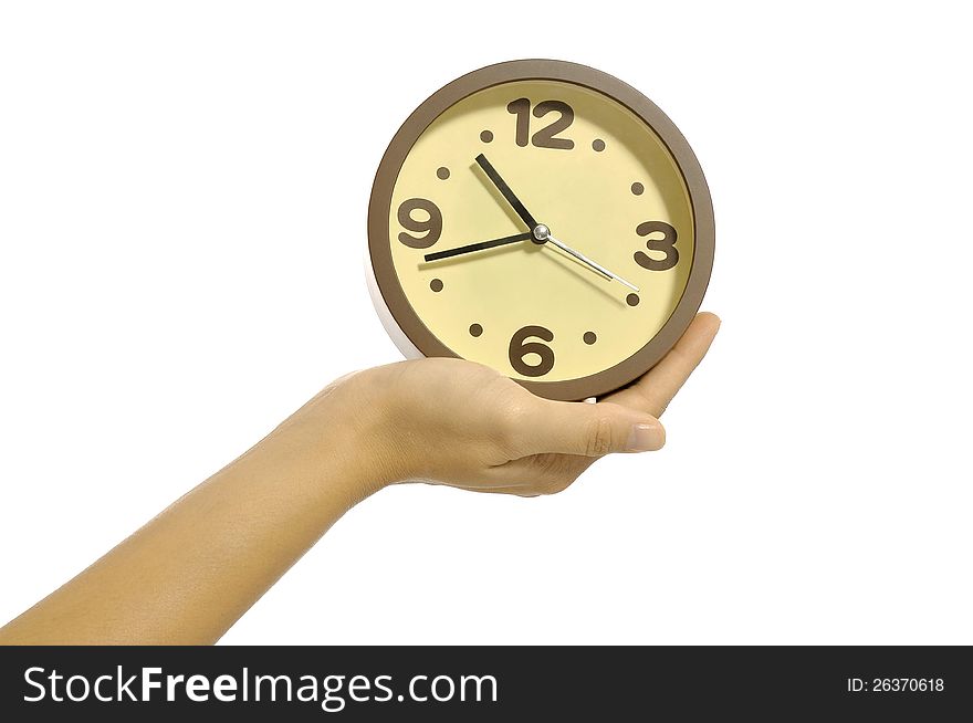 Hand holding clock isolated over white background. Overtime concept