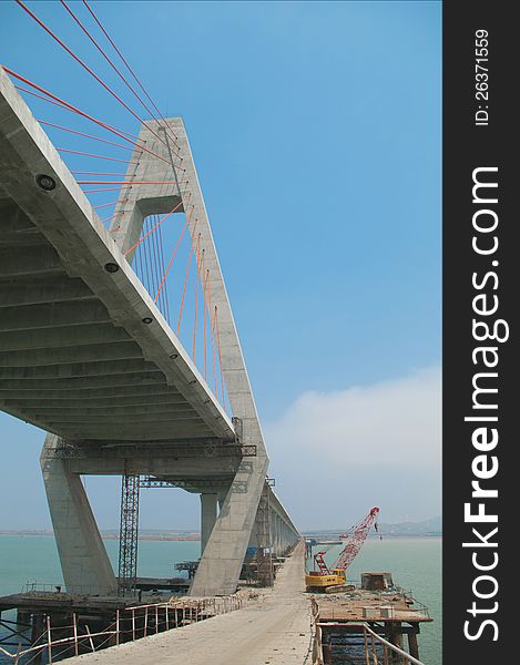 Construction of cross-sea bridge  from a low point of view. Construction of cross-sea bridge  from a low point of view