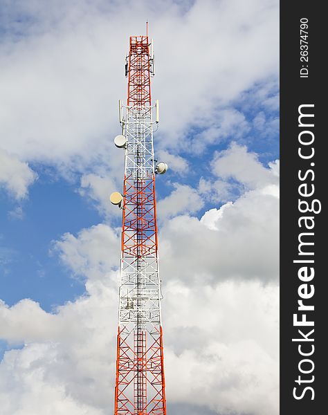 Telecommunication mast with cloudy sky.
