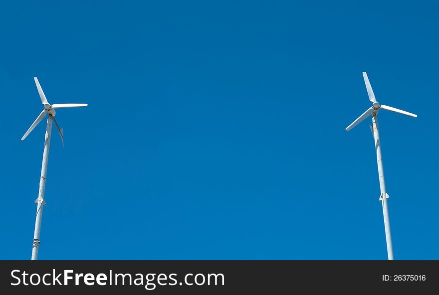 Wind turbine on blue sky background