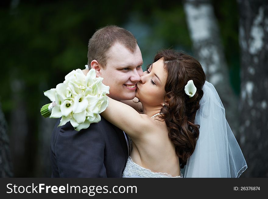 Kissing bride and groom at wedding walk