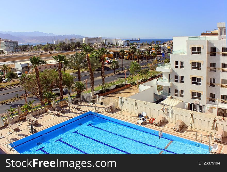 Beautiful view of the pool, palm avenue and modern hotels in the Red Sea resort. Eilat, Israel. Beautiful view of the pool, palm avenue and modern hotels in the Red Sea resort. Eilat, Israel
