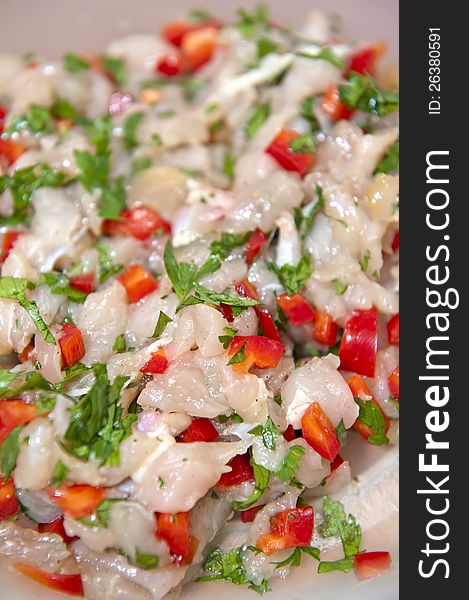 Close-up view of chopped raw chicken meat mixed with parsley and paprika. Mix for cutlets.