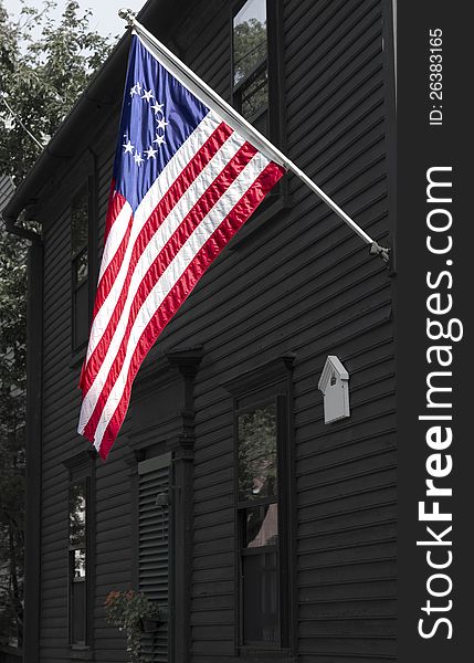 American flag Betsy Ross version on and old style house