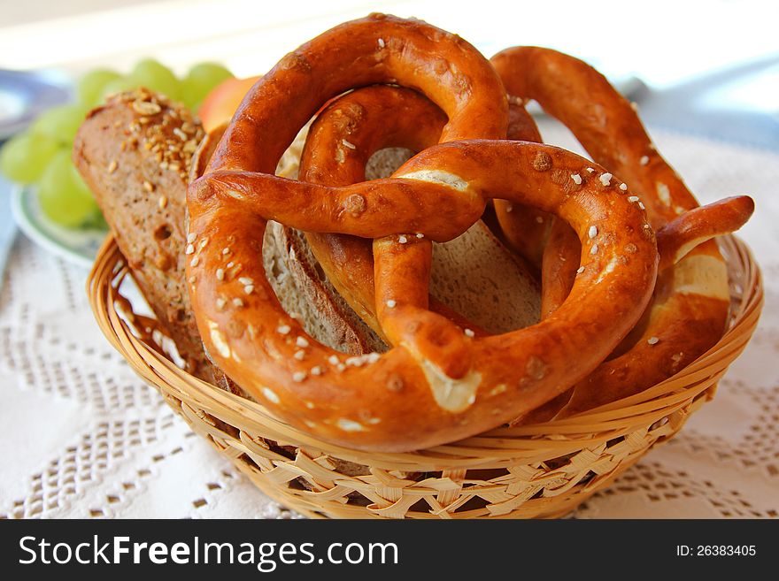 A basket of Freshly baked Bavarian Pretzel (Brezel) and other types of bread. A basket of Freshly baked Bavarian Pretzel (Brezel) and other types of bread