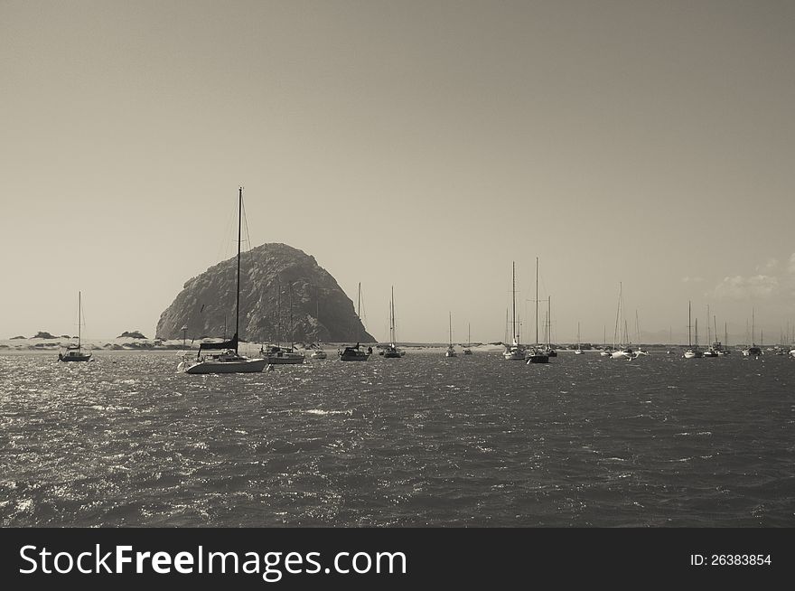 View of sailboats on Morro Bay with Morro Rock in the background.