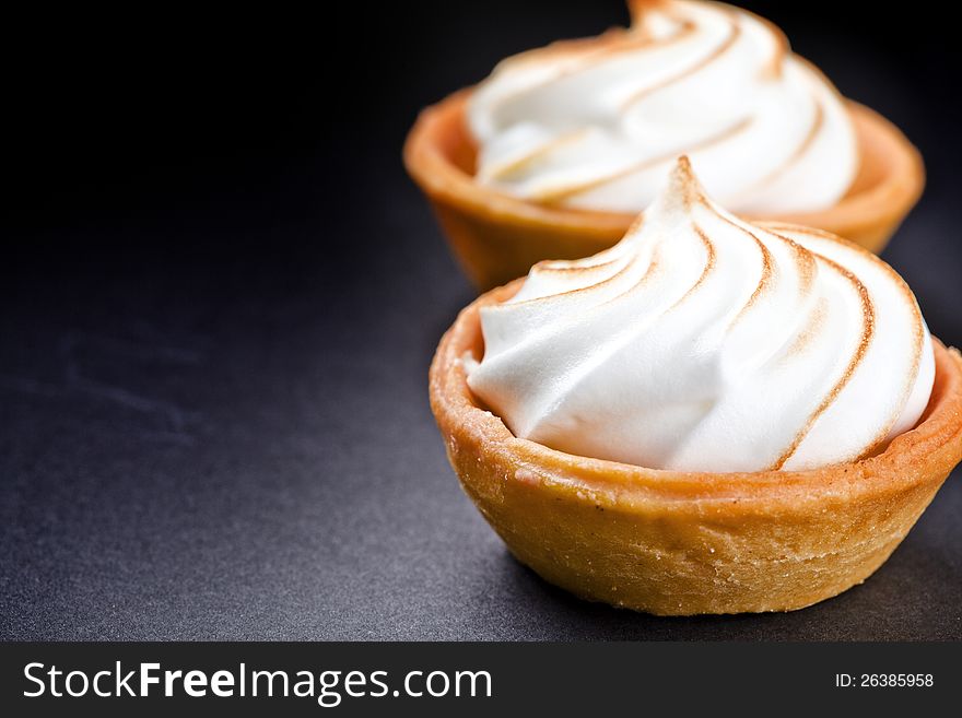 Close up photograph of two tasty lemon pies