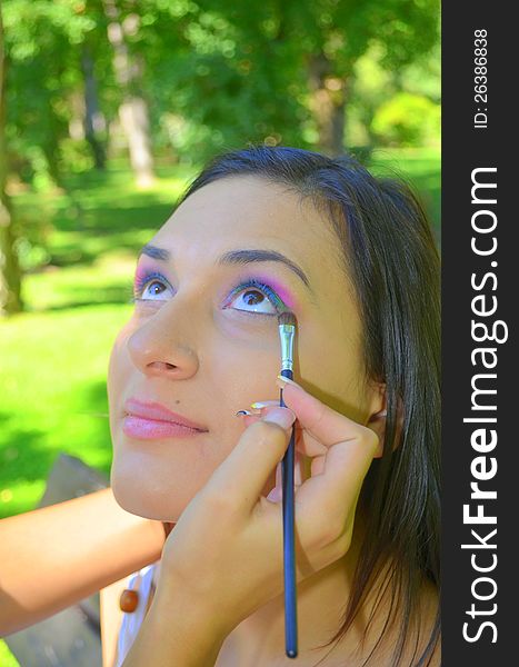 Image of a makeup session in an outside garden. Image of a makeup session in an outside garden