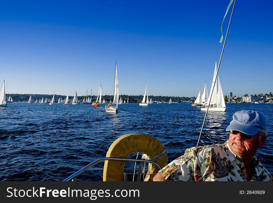 Skipper at the wheel of his sailboat. Skipper at the wheel of his sailboat