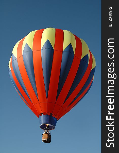 Colorful hot air balloon floating in the blue summer sky