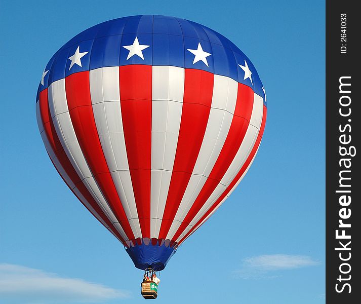 Colorful hot air balloon floating in the blue summer sky