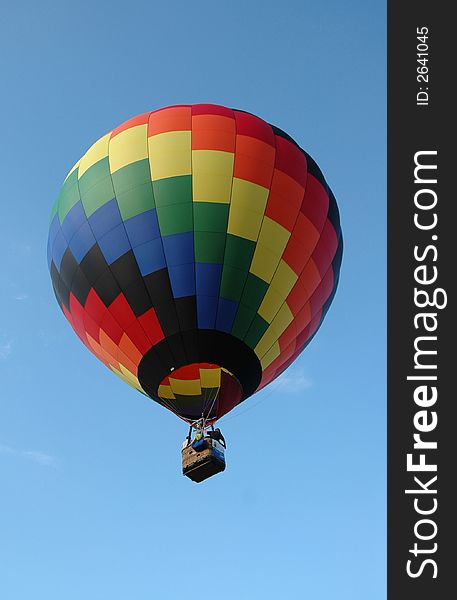 Colorful hot air balloon floating in the blue summer sky