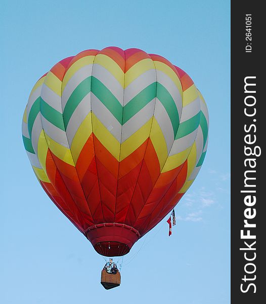 Colorful hot air balloon floating in the blue summer sky