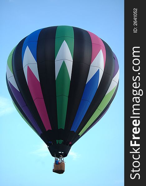 Colorful hot air balloon floating in the blue summer sky