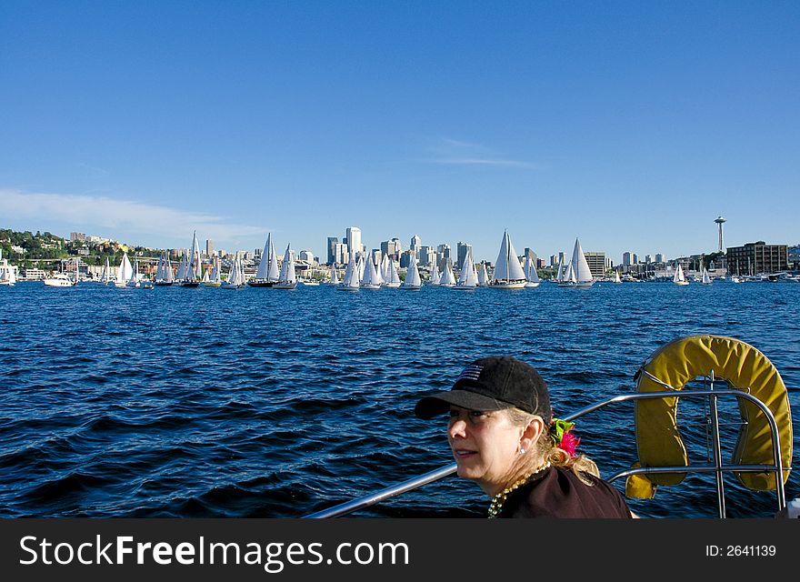 Sailboat crew member with downtown Seattle and sailboats