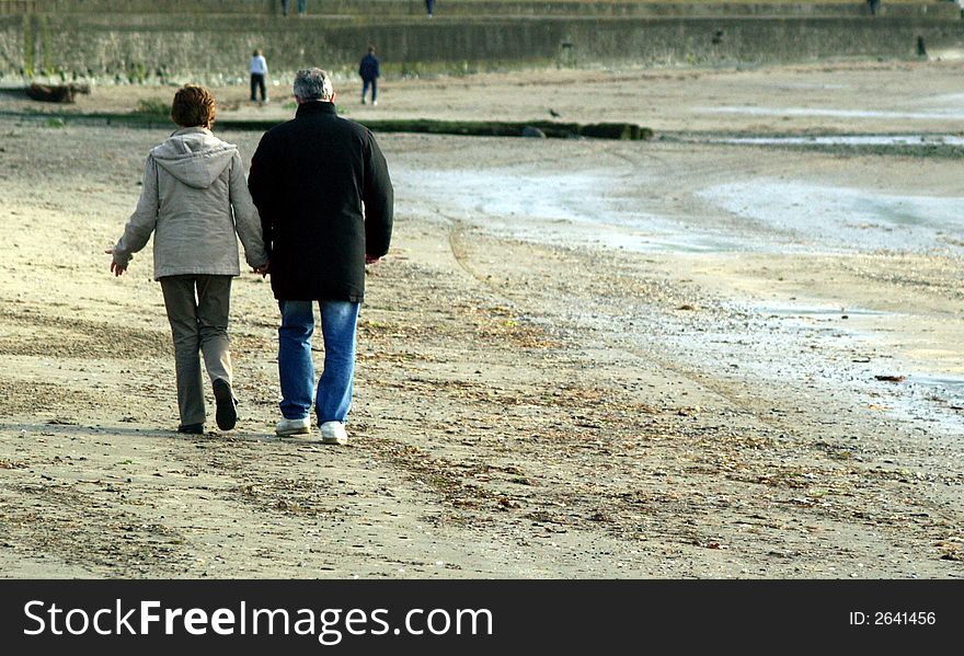 Older couple on beach holding hands. Older couple on beach holding hands