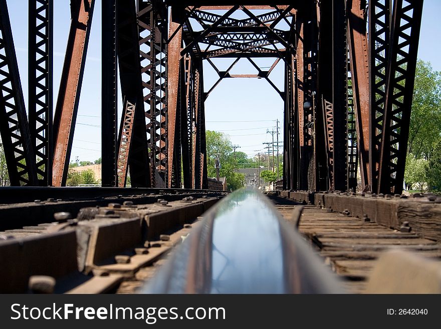 An old rail bridge looking down the rail.