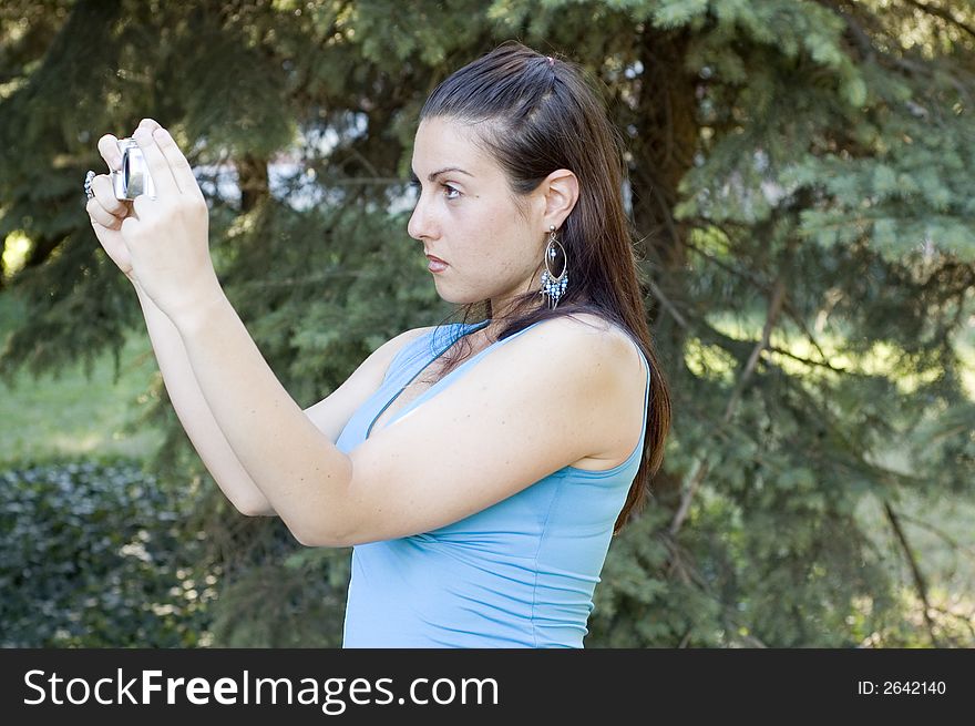 Girl photographer against the forest