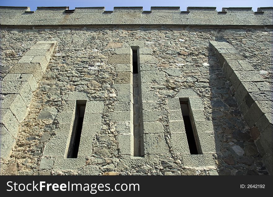 Loophole in a defensive wall ancient castle (the Crimean peninsula)