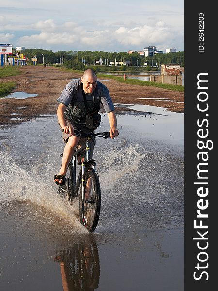 Man on the bike crossing the water. Man on the bike crossing the water