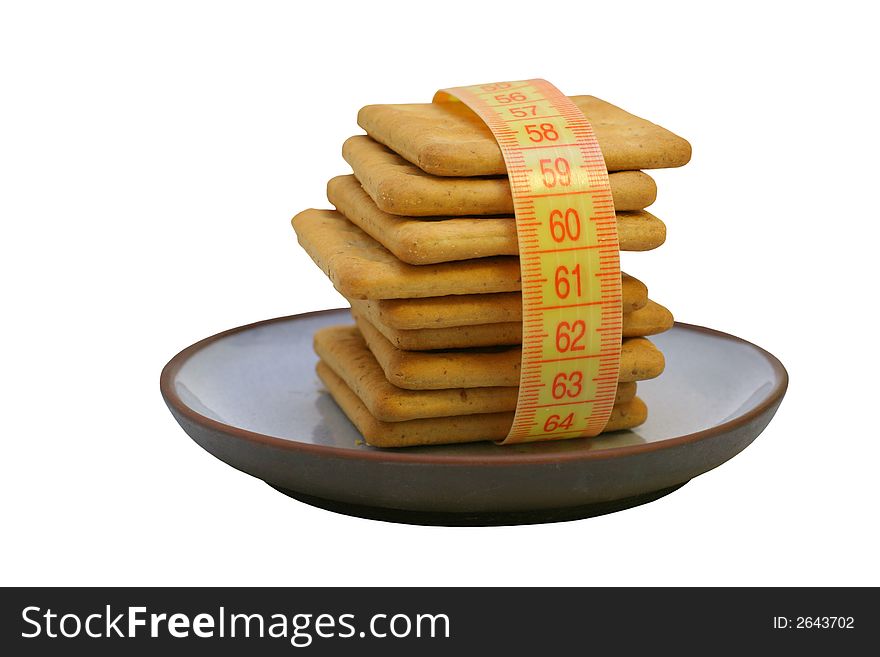 Cookies on plate with measure tape, isolated.