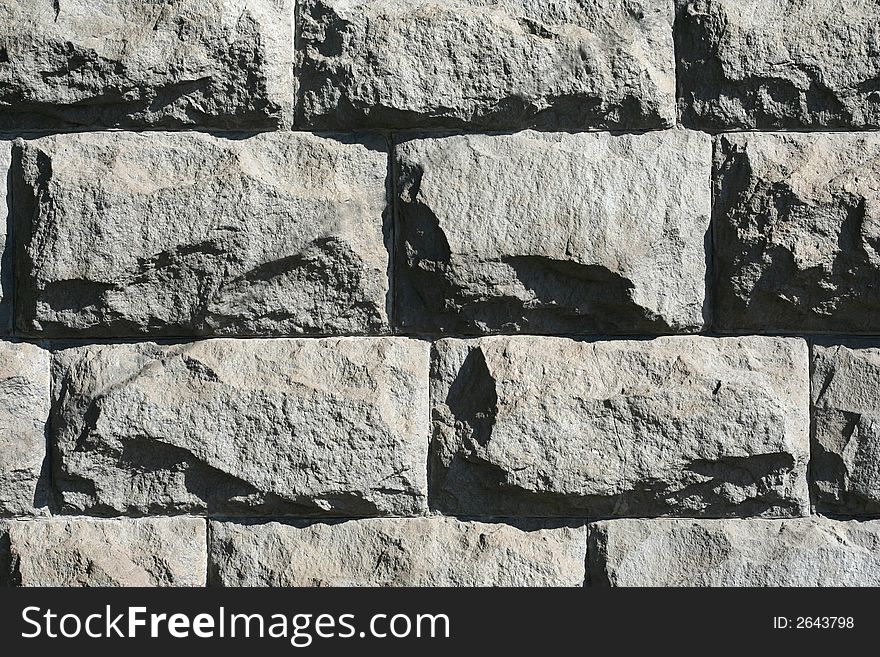 Rough stone wall in a morning sunlight as a background