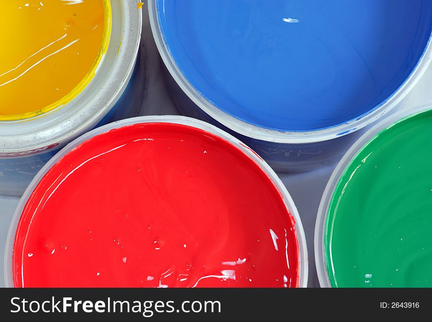 Vertical picture of paints in red,blue,green and yellow. Vertical picture of paints in red,blue,green and yellow
