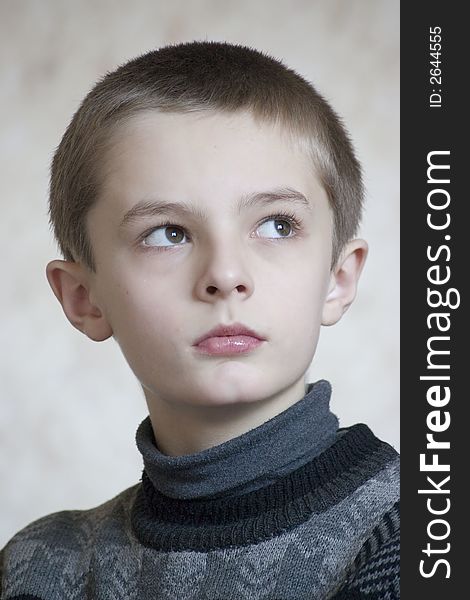 Serious boy portrait on light background