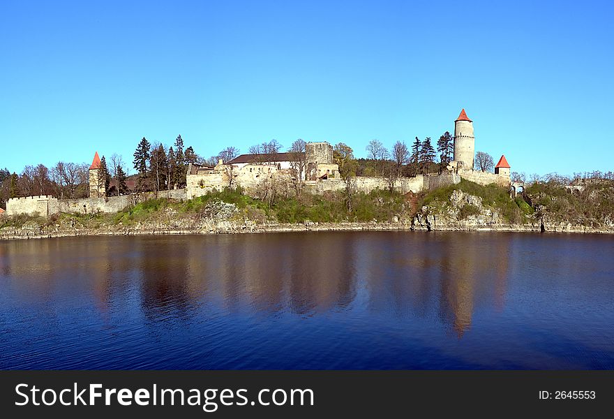 Old medieval czech castle with turrets, walls and a lake around it. Old medieval czech castle with turrets, walls and a lake around it.
