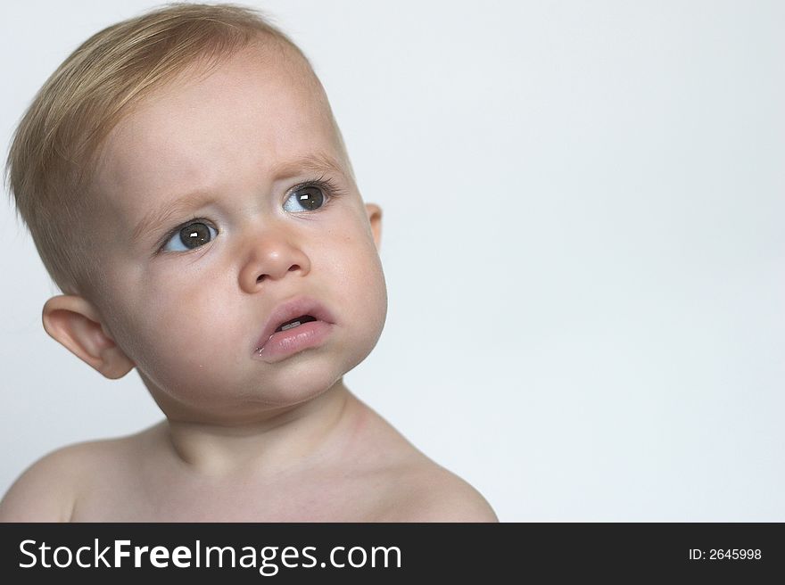 Image of beautiful toddler with a serious look on his face