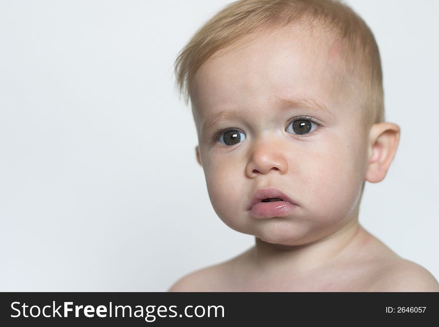 Image of beautiful toddler with a serious look on his face