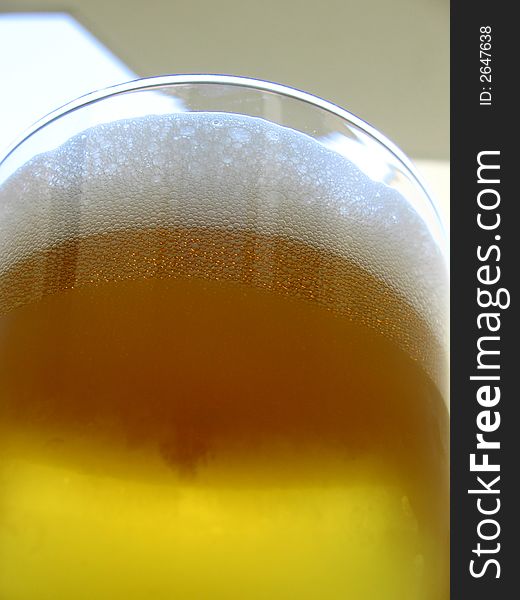 Drinking time... cold beer in summer time, beer in glass, focus on beer froth,. Drinking time... cold beer in summer time, beer in glass, focus on beer froth,