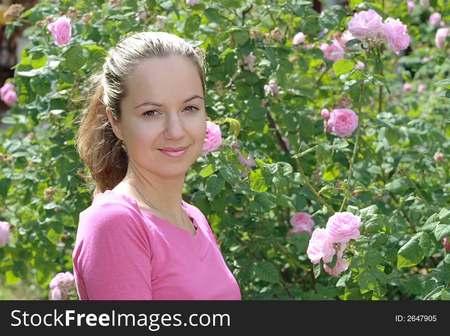 Beautiful young smiling girl portrait with foliage