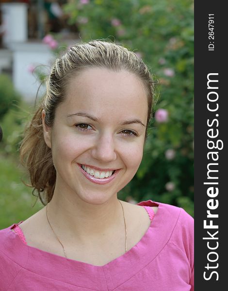 Beautiful young smiling girl portrait with foliage