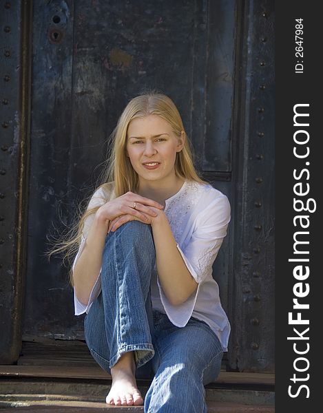 Young blond woman gazing at the camera with a pretty smile. Young blond woman gazing at the camera with a pretty smile.