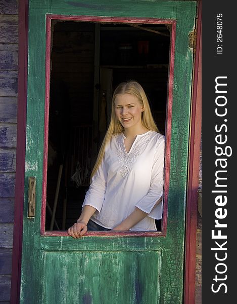 Young blond woman gazing at the camera with a pretty smile. Young blond woman gazing at the camera with a pretty smile.