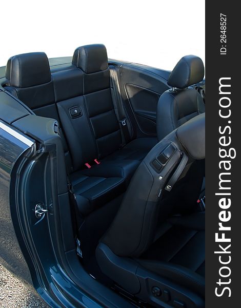 Interior rear seat of convertible with the top down.