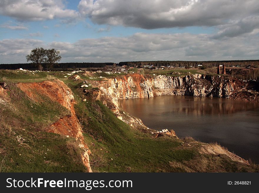 Landscape with the old marble mine filled by water. Landscape with the old marble mine filled by water.