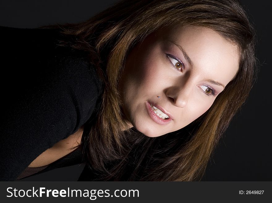 Attractive brunette looking into the light showing her beautiful brown eyes